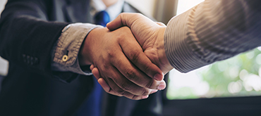 Two people shaking hands. 