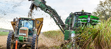 Farm equipment running in field and harvesting. 